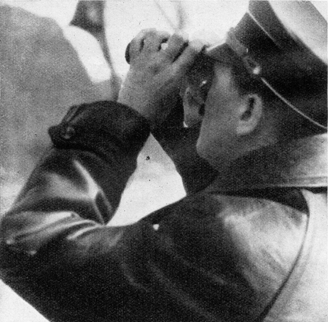 Adolf Hitler on the Rhine river aboard the Preussen steam boat, looking at the landscape with binoculars